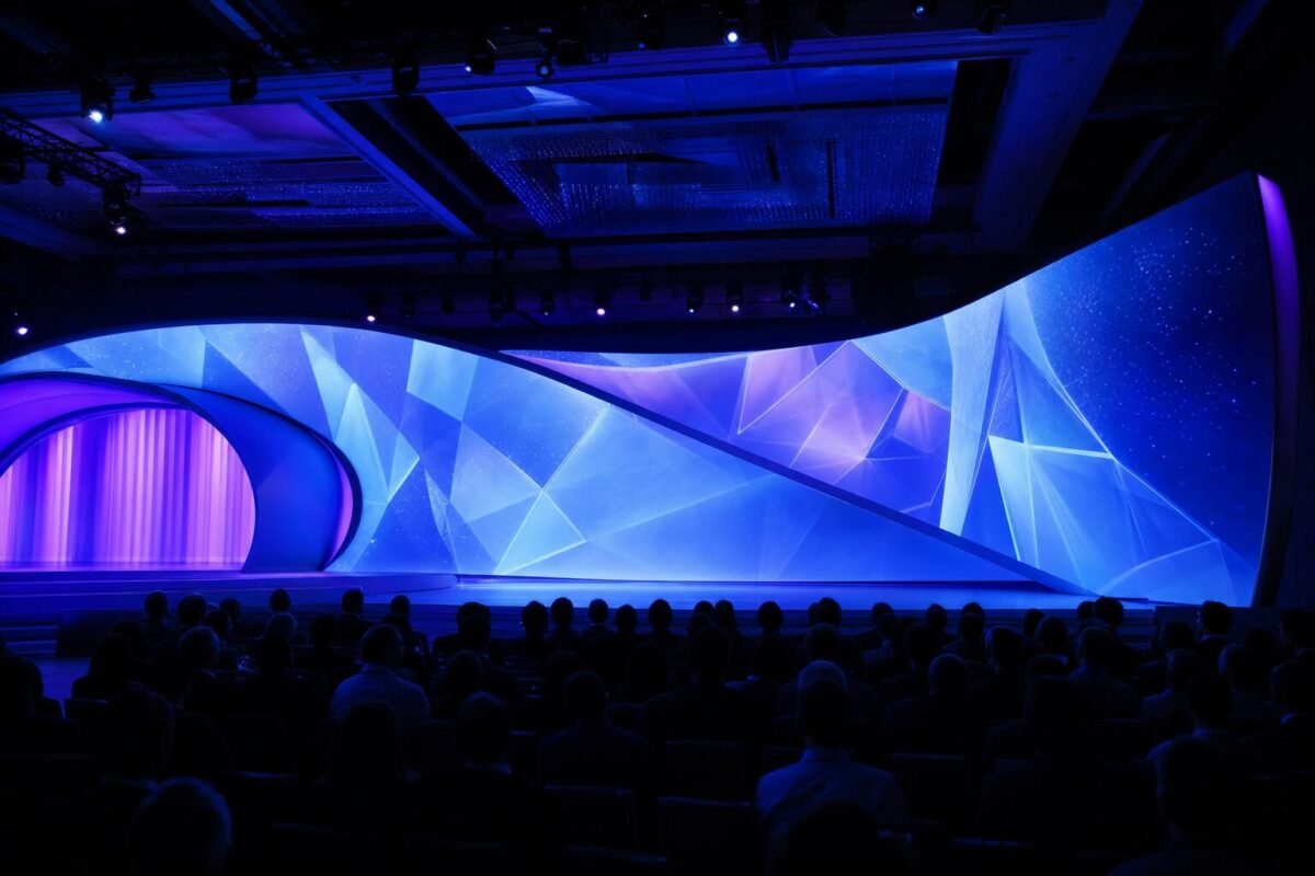 Projection mapping on a curved stage backdrop at a corporate event