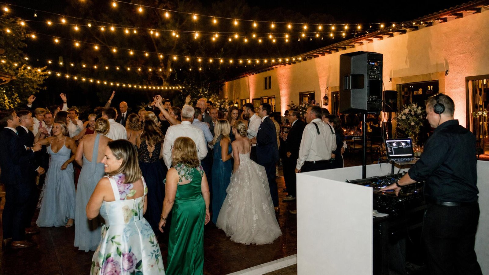 Guests dancing near the DJ booth at a wedding reception in Southern California
